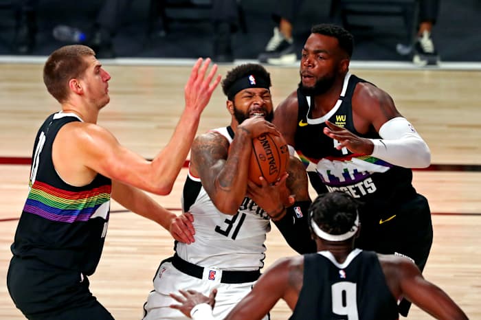 LA Clippers forward Marcus Morris Sr. (31) drives to the basket against Denver Nuggets forward Paul Millsap (4) during the first quarter in game six of the second round of the 2020 NBA Playoffs